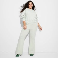 Fleece flare sweatpants from Wild Fable™ in a solid hue. Tailored in a high-rise silhouette with flared legs. Made of heavyweight cotton-recycled polyester fabric for flexible all-day comfort. Designed with a full elastic waistband for a secure, stay-put fit, plus side pockets for functional flair. If you're not satisfied with any Target Owned Brand item, return it within one year with a receipt for an exchange or a refund. Wild Fable™: A look for every story. Flare Sweatpants, Wide Leg Lounge Pants, Recycled Polyester Fabric, High Waisted Flares, Flare Leggings, Hem Style, Fleece Pants, Womens Fleece, Bottom Clothes