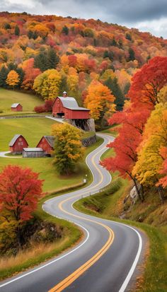 a country road winding through the countryside with colorful trees on both sides and a barn in the distance