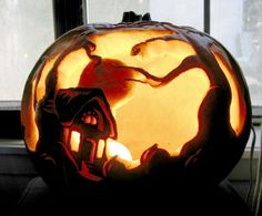 a carved pumpkin sitting on top of a window sill