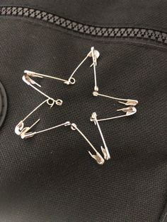 a star pin sitting on top of a black piece of luggage