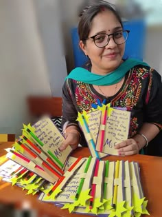 a woman sitting at a table with lots of sticky notes in front of her face