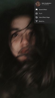 a blurry photo of a woman's face with long hair in the dark