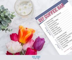 a cup of coffee next to flowers and a checklist on a marble surface with the words diy coffee bar