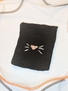 This kids hat was made with black baby yarn so it is incredibly soft! A pink nose was crocheted and sewed on the front along with 6 white whiskers. It is 6.5 inches wide and 8 inches tall. There is moderate stretch allowance to fit many sizes. Any questions please ask! Black Novelty Beanie One Size Fits Most, Novelty Black Beanie, One Size Fits Most, Black One Size Cat Ears Hat, Black Novelty Beanie, Playful Handmade Black Hats, Black Cat Ears Hat With Cat Design, Black Cat Design Hat With Cat Ears, Fun Black Warm Hats, Black Hat With Cat Ears And Cat Design