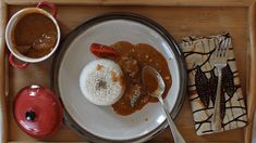 a tray with rice, beans and meat on it