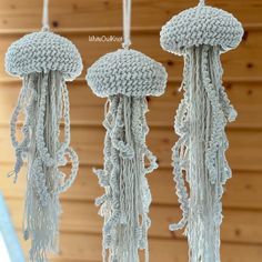 three crocheted jellyfish hanging from hooks