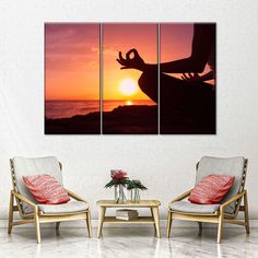 the silhouette of a person doing yoga in front of an orange and pink sunset over water