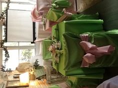 the tables are covered with green cloths and pink bows