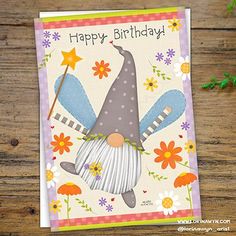 a birthday card with an image of a gnome holding a broom and flowers on it