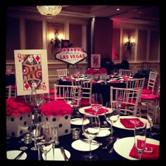 the tables are set for an event with red and white centerpieces