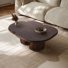 a coffee table sitting on top of a white rug