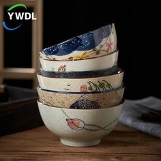 a stack of bowls sitting on top of a wooden table