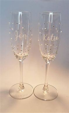 two wine glasses sitting next to each other on a table