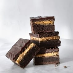 five pieces of chocolate cake stacked on top of each other with peanut butter in the middle