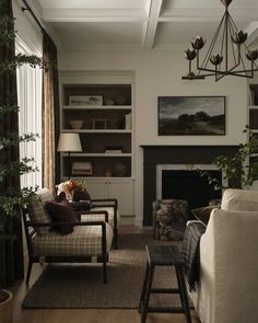 a living room filled with furniture and a fire place