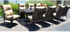 an outdoor dining table and chairs with beige cushions