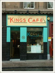 a king's cafe on the corner of a street in front of a building