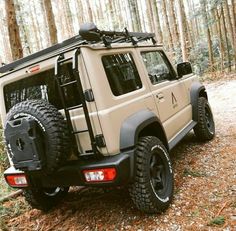 an off - road vehicle is parked in the woods