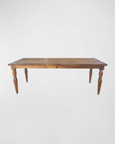 an old wooden table with two legs on the top and one leg raised up to the ground