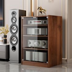 there are two speakers in the room and one speaker is on top of a cabinet