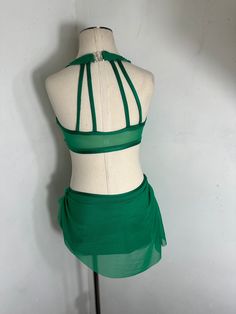 a mannequin with a green skirt on it's head and neckline