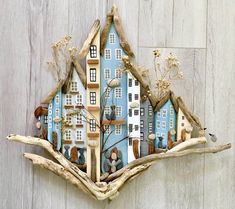 a blue house made out of driftwood on a wooden wall