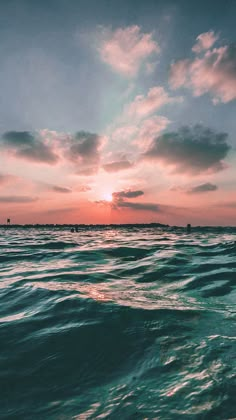 the sun is setting over the ocean as it reflects in the water's surface