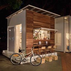 a bike is parked in front of a small house that's built into the ground