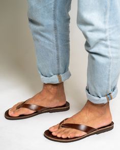 These men's leather flip flop sandals are crafted from natural Greek leather, and feature a minimalist design with flat soles for ultimate comfort during the summer season. The barefoot thong design offers a free, relaxed feel, while the leather material allows for breathability and durability. Perfect for casual wear or beach outings. All of our products are handmade with the best and highest quality leather from our beloved island of ''Crete''.  The leather used for each item may be irregular Leather Lined Flip Flops For Summer Beach, Summer Leather Lined Flip Flops For The Beach, Summer Beach Flip Flops With Leather Lining, Vacation Leather Lined Single Toe Strap Flip Flops, Summer Leather Toe Loop Flip Flops, Casual Leather Flip Flops With Single Toe Strap, Summer Leather Slippers With Stitched Sole, Leather Slippers With Stitched Sole For Summer, Leather Flip Flops With Rubber Sole For Beach