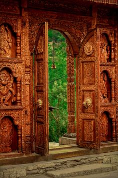 two wooden doors with carvings on them