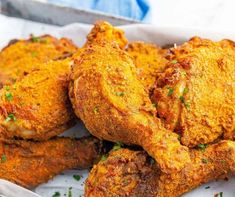 fried chicken in a basket with parsley on the side, ready to be eaten