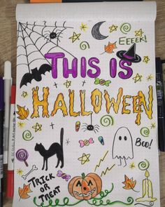 this is halloween written on a notebook with markers