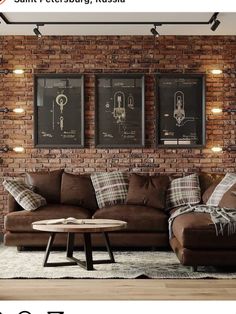 a living room with brick walls and two pictures on the wall above the couches