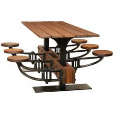 a wooden table with six stools on it and an iron frame around the top