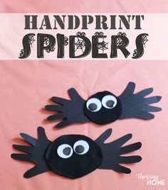 two handprinted spider puppets sitting on top of a pink sheet