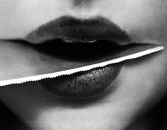 a woman's mouth with a knife in it to cut the lip off of her lips