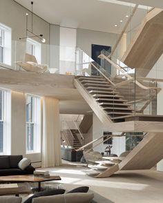 a living room filled with furniture and a staircase