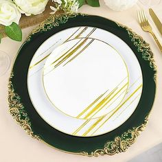 a white and green plate sitting on top of a table with gold trimmings