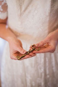 a woman holding a golden key in her hands