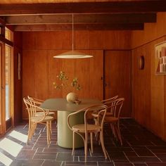 a dining room with wooden walls and flooring