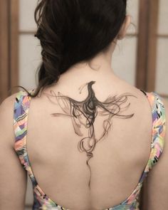 a woman with a tattoo on her back