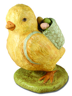 a yellow bird figurine with a green bag on it's back legs