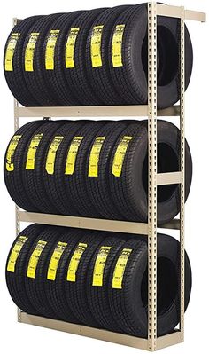 four rows of tires are stacked up on the shelf in front of each other with yellow labels