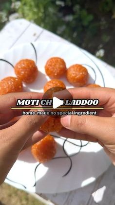 someone is holding some oranges in their hand and pointing to them with the word match laddo on it