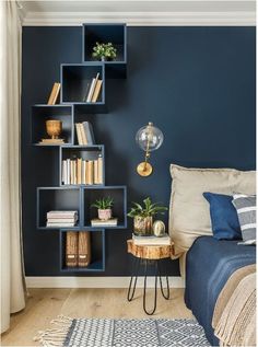 a bed room with a neatly made bed and bookshelves