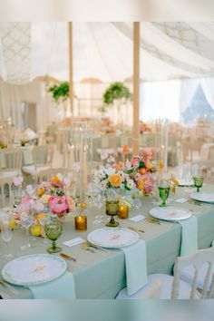 the tables are set with flowers and plates