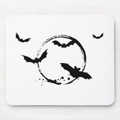 bats are flying around the letter c mouse pad, which is designed to look like a circle