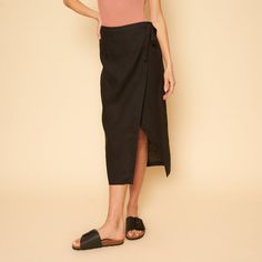 The Valentina Skirt Is A Linen Mid-Length Wrap Skirt. Black Summer Pencil Skirt, Black Lined Relaxed Skirt Bottoms, Chic Black Asymmetrical Wrap Skirt, Versatile Black Midi Skirt, Versatile Black Mini Skirt, Black Mini Wrap Skirt For Spring, Versatile Black Asymmetrical Skirt, Long Black Pencil Skirt For Spring, Black Long Pencil Skirt For Spring