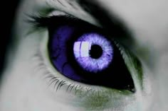 the iris of an eye is glowing purple