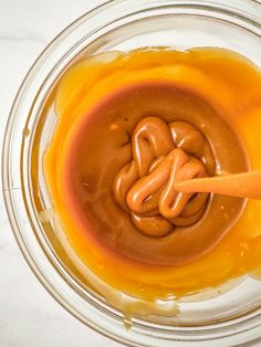 a glass bowl filled with caramel sauce and pretzels in the batter mixture